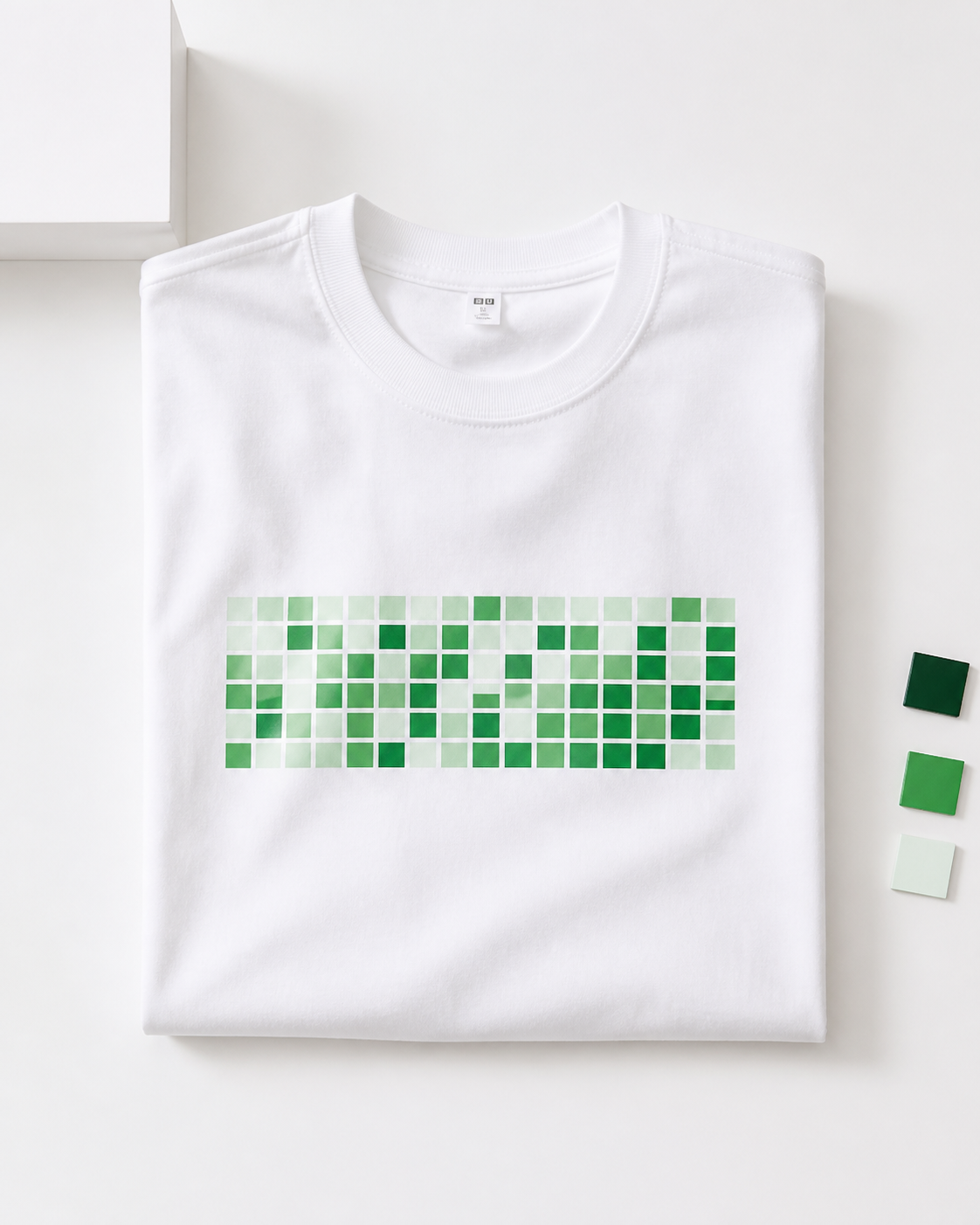 Flat-lay white contribution-grid T-shirt with green product blocks